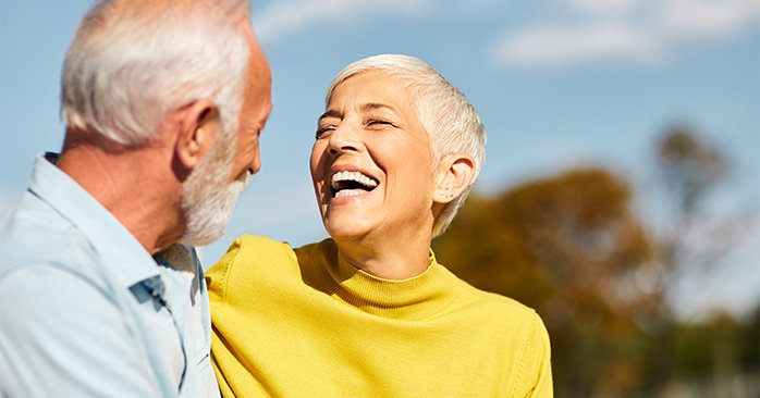 Older couple laughing.